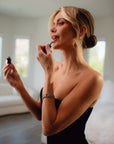 Woman applying Lush Lip oil by Bella Vida Santa Barbara