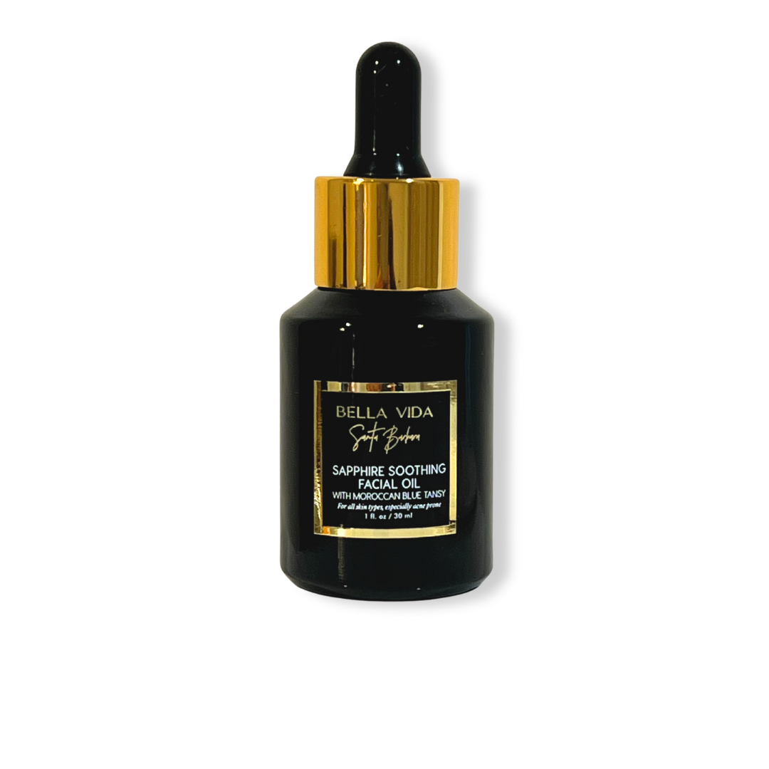 Black facial oil bottle with gold cap on a white background Bella Vida Santa Barbara Sapphire oil with blue tansy for acne prone and oily skin